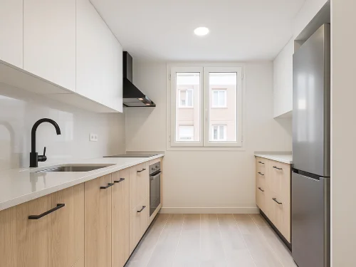 Cocina reformada en Mataró con diseño lineal, muebles de madera clara y electrodomésticos integrados